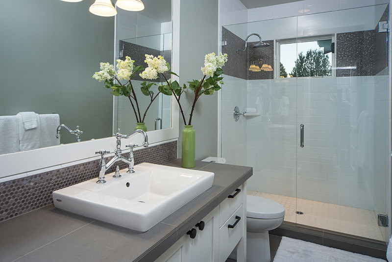 Inspiration for a transitional 3/4 bathroom in Other with a drop-in sink, recessed-panel cabinets, white cabinets, tile benchtops, a curbless shower, gray tile, porcelain tile, green walls and ceramic floors.