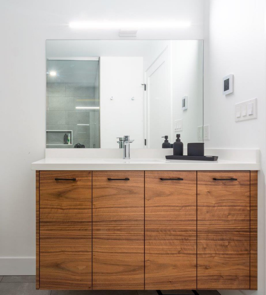 Inspiration for a large contemporary kids bathroom in Other with flat-panel cabinets, light wood cabinets, an alcove shower, a one-piece toilet, white tile, porcelain tile, white walls, porcelain floors, an undermount sink, engineered quartz benchtops, grey floor, an open shower and white benchtops.
