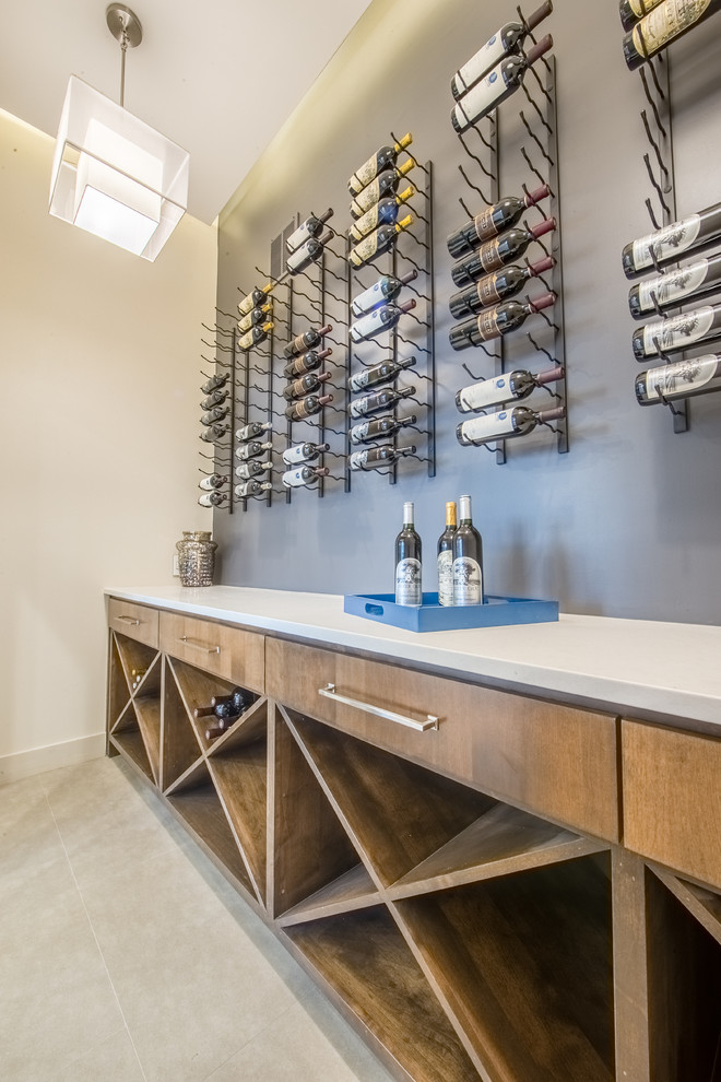 Mid-sized contemporary single-wall wet bar in Austin with medium wood cabinets, solid surface benchtops, porcelain floors and open cabinets.