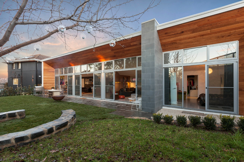 Inspiration for a contemporary one-storey exterior in Canberra - Queanbeyan with wood siding and a flat roof.