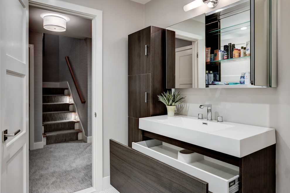 Transitional master bathroom in Boston with an alcove shower, white tile, subway tile, flat-panel cabinets, dark wood cabinets, white walls, an integrated sink and solid surface benchtops.