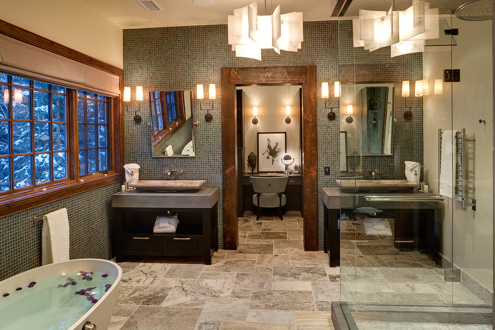 Large contemporary master bathroom in Denver with a freestanding tub, mosaic tile, a vessel sink, flat-panel cabinets, dark wood cabinets, soapstone benchtops, a corner shower, gray tile, beige walls, limestone floors and multi-coloured floor.