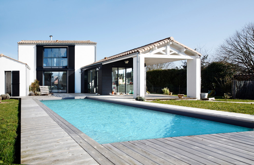 Inspiration for a large country backyard rectangular pool in Nantes with decking.