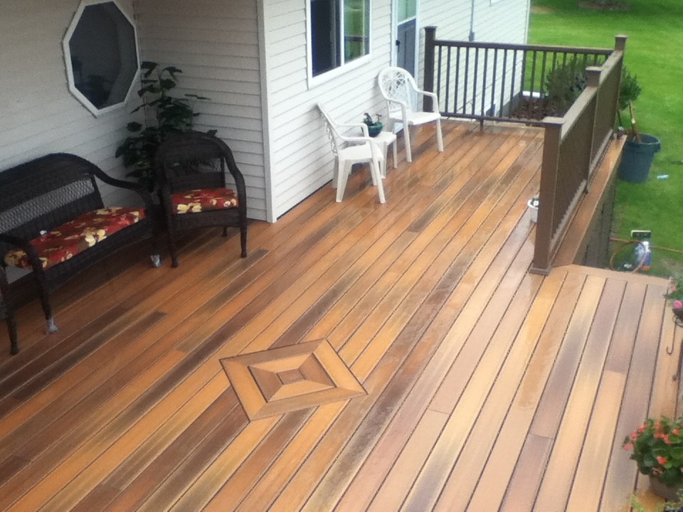 Example of a large island style backyard deck design with no cover