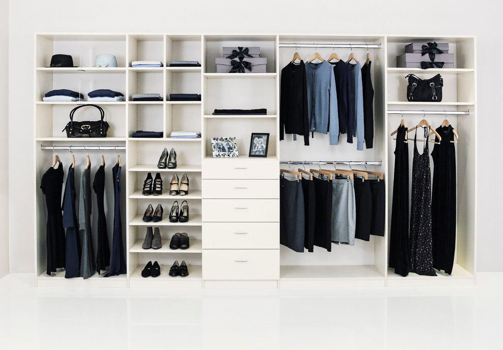 Inspiration for a large traditional gender-neutral built-in wardrobe in Los Angeles with white cabinets and flat-panel cabinets.