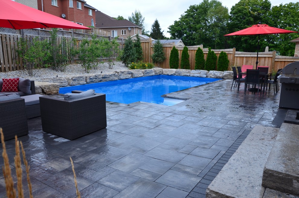Pool - mid-sized transitional backyard concrete paver and rectangular lap pool idea in Toronto