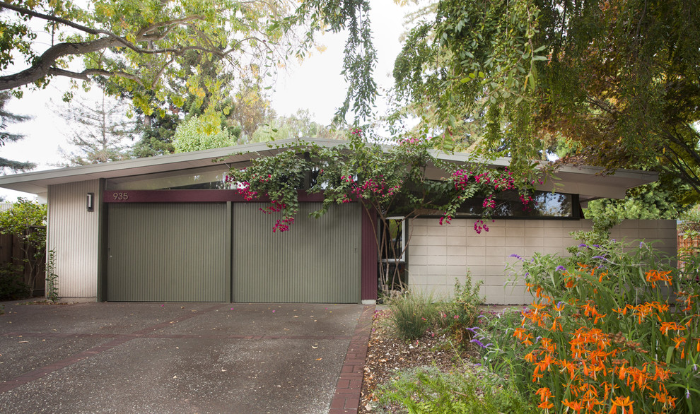 This is an example of a midcentury concrete exterior in San Francisco with a gable roof.