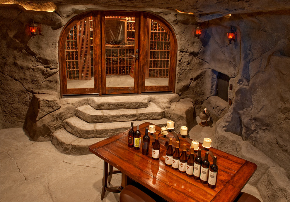 Inspiration for an expansive traditional wine cellar in Other with concrete floors and storage racks.