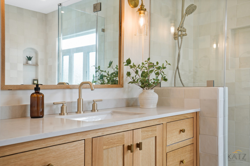 Cette image montre une salle de bain principale marine en bois clair avec un placard à porte affleurante, une baignoire d'angle, une douche d'angle, WC à poser, un carrelage beige, un mur beige, un sol en carrelage de céramique, un lavabo encastré, un sol beige, un plan de toilette beige, meuble simple vasque et meuble-lavabo encastré.