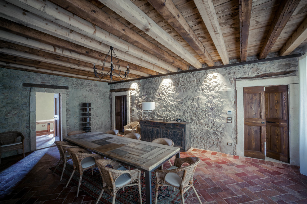 Inspiration for a large country dining room in Other with terra-cotta floors.