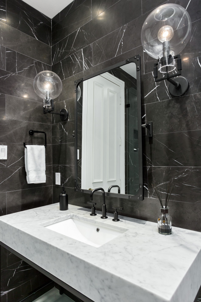 Inspiration for a small traditional 3/4 bathroom in Dallas with furniture-like cabinets, grey cabinets, an alcove shower, a one-piece toilet, marble, marble floors, an undermount sink, marble benchtops, a hinged shower door, grey benchtops, a niche, a single vanity, a freestanding vanity, black tile, black walls, white floor and panelled walls.