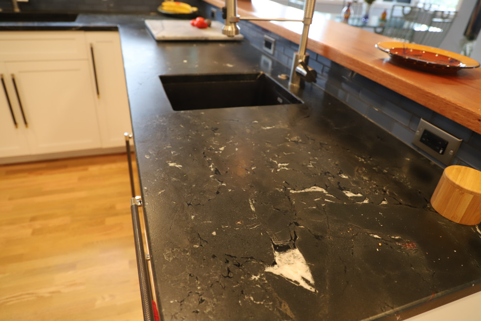 Inspiration for a mid-sized transitional u-shaped medium tone wood floor and brown floor eat-in kitchen remodel with shaker cabinets, white cabinets, granite countertops, blue backsplash, stainless steel appliances, black countertops, an undermount sink, stone tile backsplash and a peninsula