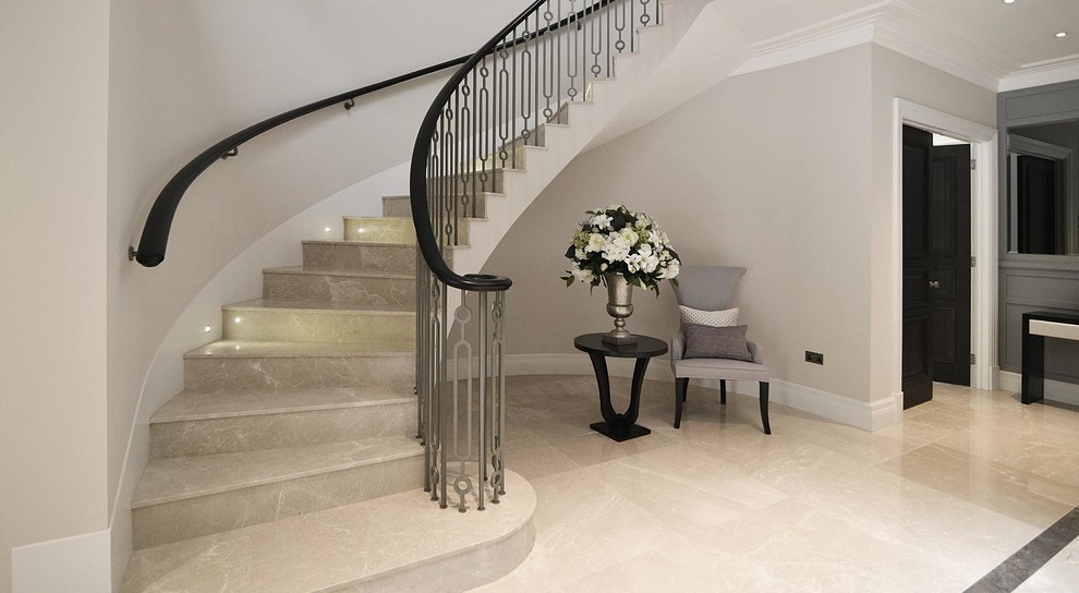 Mid-sized contemporary marble spiral staircase in London with marble risers.