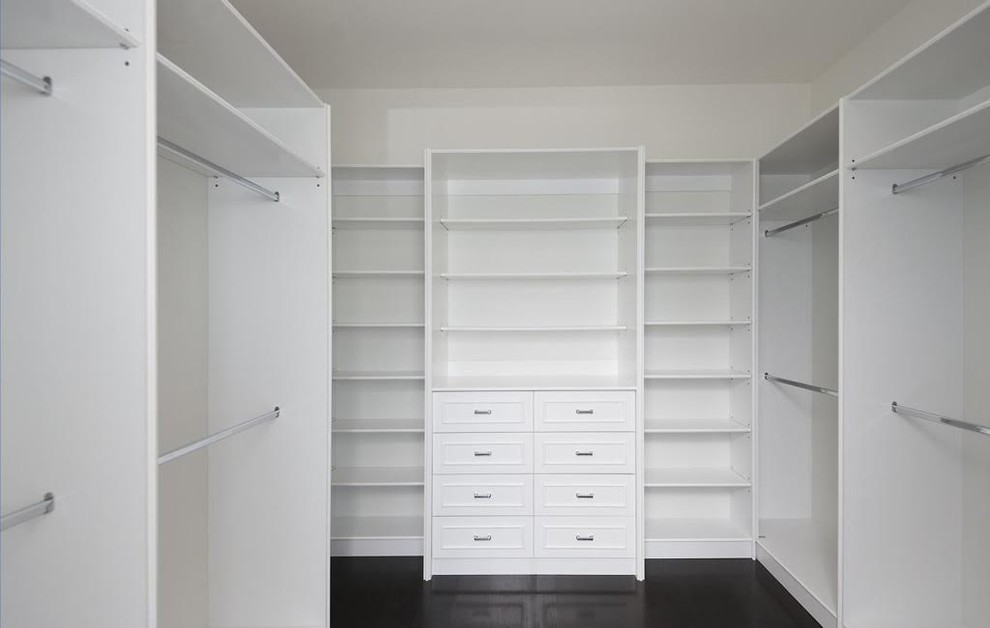 Inspiration for a large transitional gender-neutral walk-in wardrobe in Los Angeles with recessed-panel cabinets, white cabinets, dark hardwood floors and brown floor.
