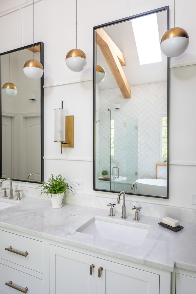 Inspiration for a mid-sized farmhouse master white tile and ceramic tile porcelain tile and brown floor bathroom remodel in Raleigh with recessed-panel cabinets, white cabinets, a two-piece toilet, white walls, an undermount sink, marble countertops, a hinged shower door and white countertops