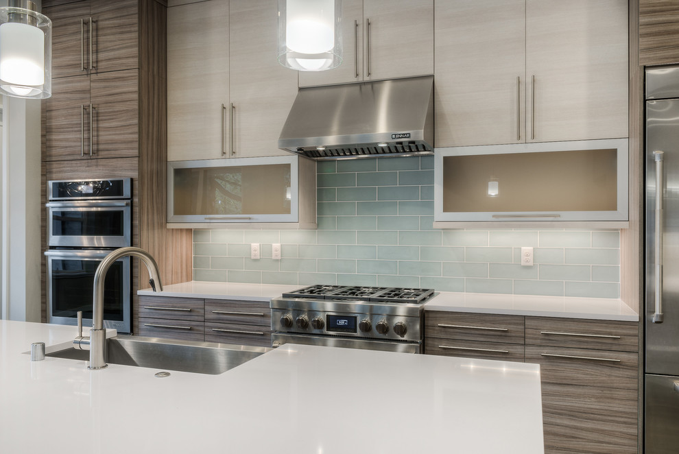 Design ideas for a transitional l-shaped open plan kitchen in Seattle with a farmhouse sink, flat-panel cabinets, light wood cabinets, quartz benchtops, blue splashback, ceramic splashback, stainless steel appliances, dark hardwood floors and with island.