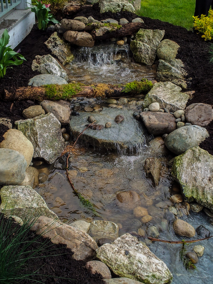 Design ideas for a mid-sized rustic full sun backyard stone formal garden in Seattle for spring.