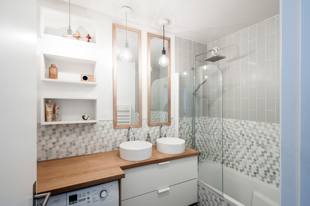 Photo of a small contemporary master bathroom in Paris with white cabinets, a shower/bathtub combo, a two-piece toilet, white tile, gray tile, mosaic tile, grey walls, a vessel sink, wood benchtops, an open shower, brown benchtops and a laundry.