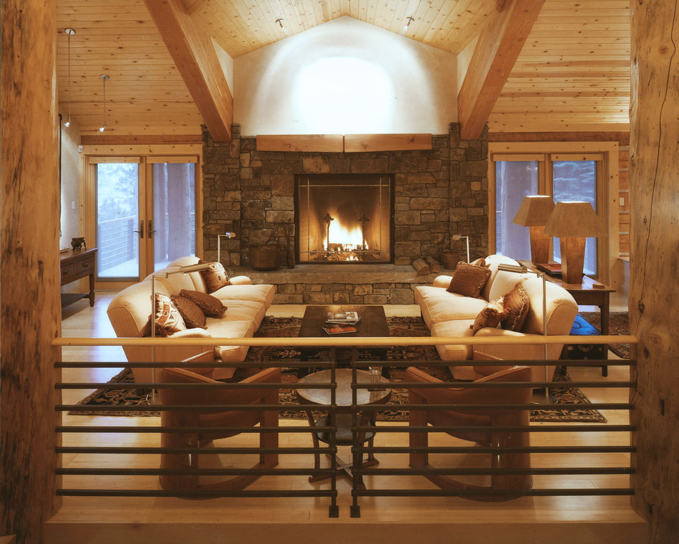 Inspiration for a mid-sized country living room in Other with light hardwood floors, a standard fireplace and a stone fireplace surround.
