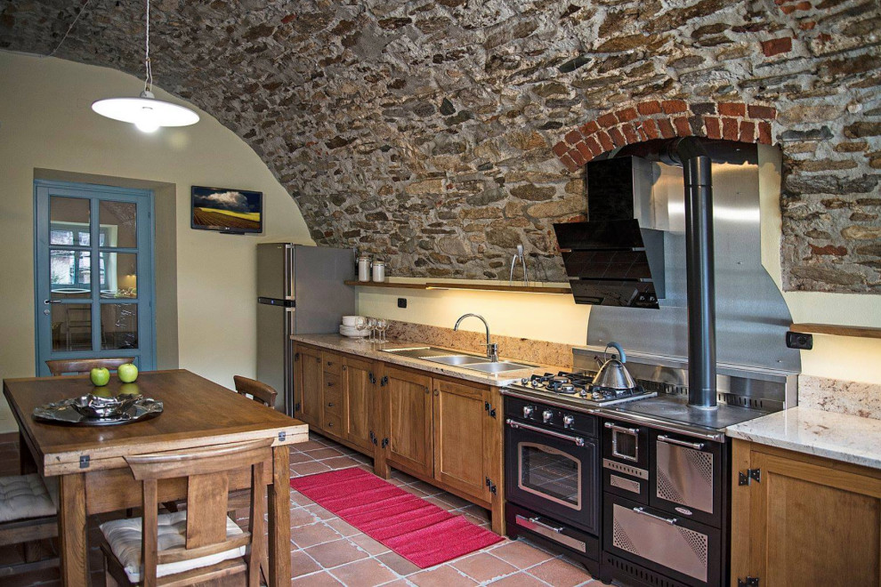 Photo of a country single-wall eat-in kitchen in Turin with a drop-in sink, recessed-panel cabinets, distressed cabinets, granite benchtops, white splashback, granite splashback, stainless steel appliances and white benchtop.