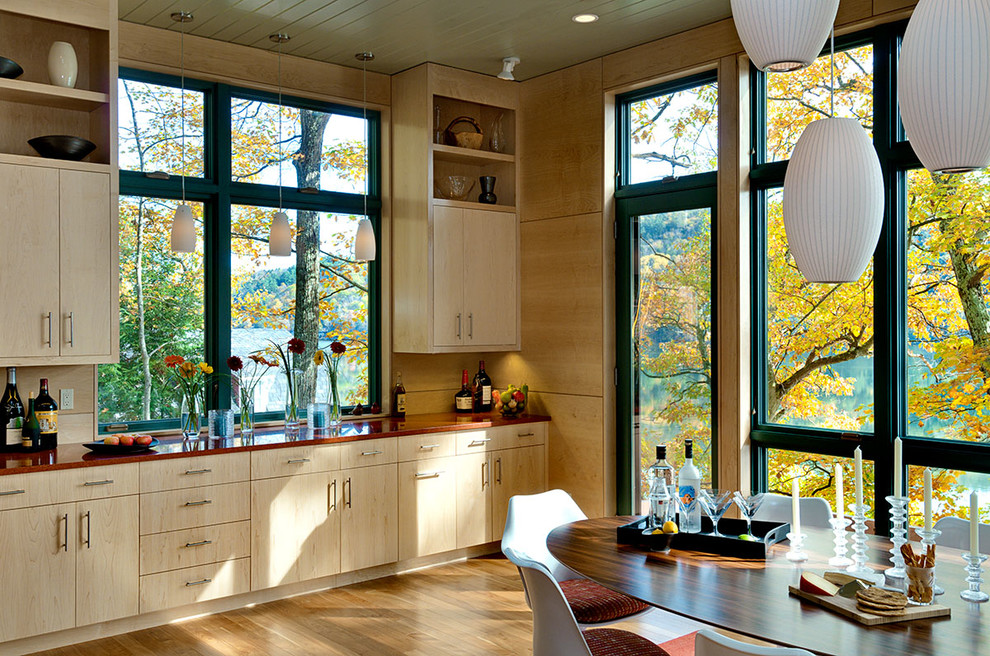 Inspiration for a contemporary eat-in kitchen in Burlington with flat-panel cabinets and light wood cabinets.