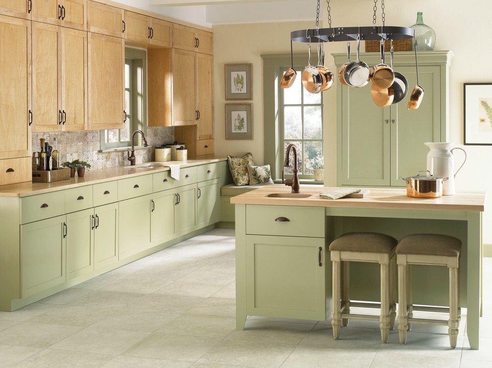 Design ideas for a traditional l-shaped eat-in kitchen in Cleveland with an undermount sink, recessed-panel cabinets, green cabinets, wood benchtops, beige splashback, stone tile splashback and coloured appliances.