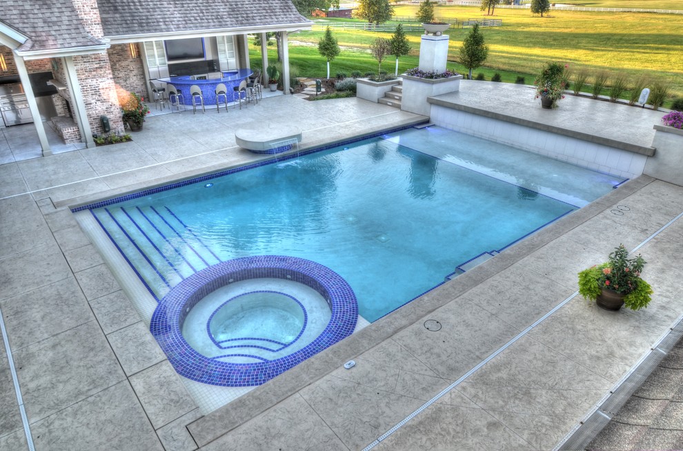 Large transitional backyard concrete paver and rectangular natural hot tub photo in Cedar Rapids