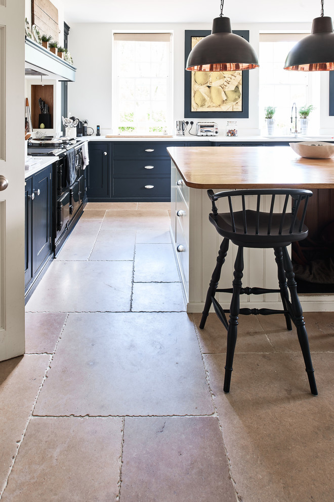 Contemporary kitchen in Wiltshire with limestone floors.