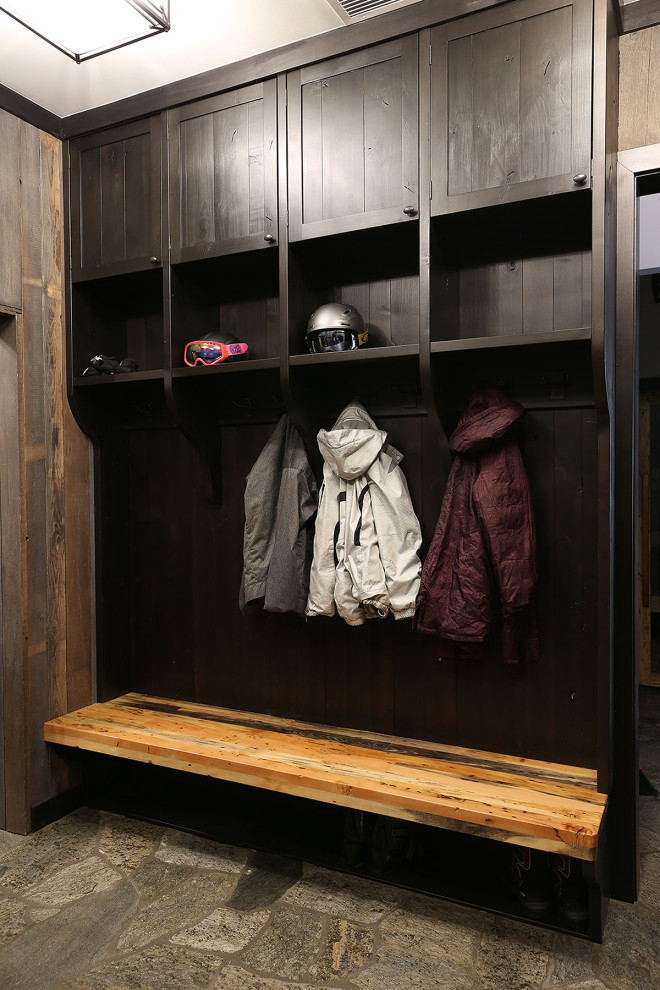 Inspiration for a large rustic gray floor mudroom remodel with a dark wood front door