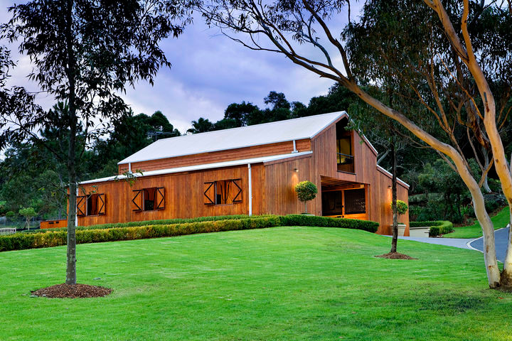 Inspiration for a traditional one-storey brown exterior in Sydney with wood siding and a shed roof.