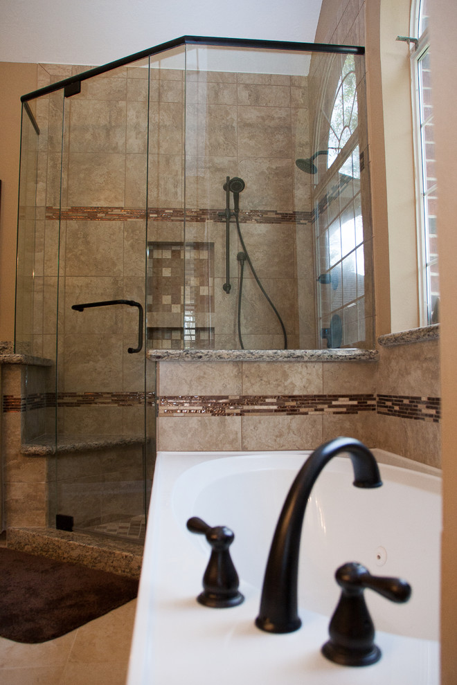 Large transitional master bathroom in Houston with granite benchtops, a corner shower, a two-piece toilet, beige tile, porcelain tile, beige walls and porcelain floors.
