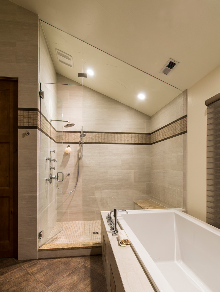 Inspiration for a large modern master bathroom in Denver with dark wood cabinets, a drop-in tub, an alcove shower, a one-piece toilet, gray tile, ceramic tile, white walls, ceramic floors, an undermount sink and granite benchtops.