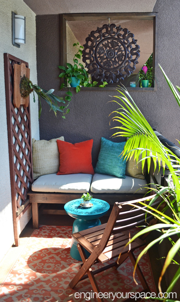 Small tropical patio in Los Angeles with a roof extension.