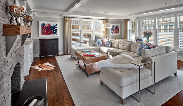 Mid-sized eclectic open concept living room in New York with grey walls, a stone fireplace surround, a wall-mounted tv, medium hardwood floors, a standard fireplace and brown floor.