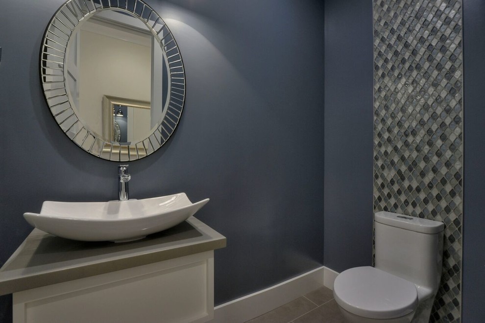 Large transitional powder room in San Francisco with shaker cabinets, white cabinets, gray tile, grey walls, marble floors, marble benchtops, a one-piece toilet, mosaic tile, a vessel sink and grey benchtops.