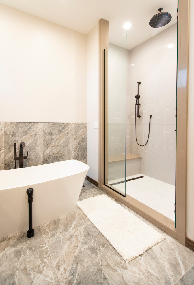 Inspiration for a large rustic master beige tile and marble tile marble floor, beige floor and wainscoting freestanding bathtub remodel with white walls and a hinged shower door