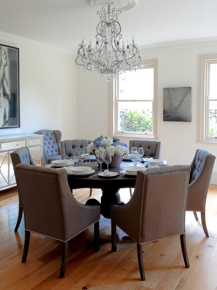Photo of a large eclectic dining room in Other with white walls and medium hardwood floors.