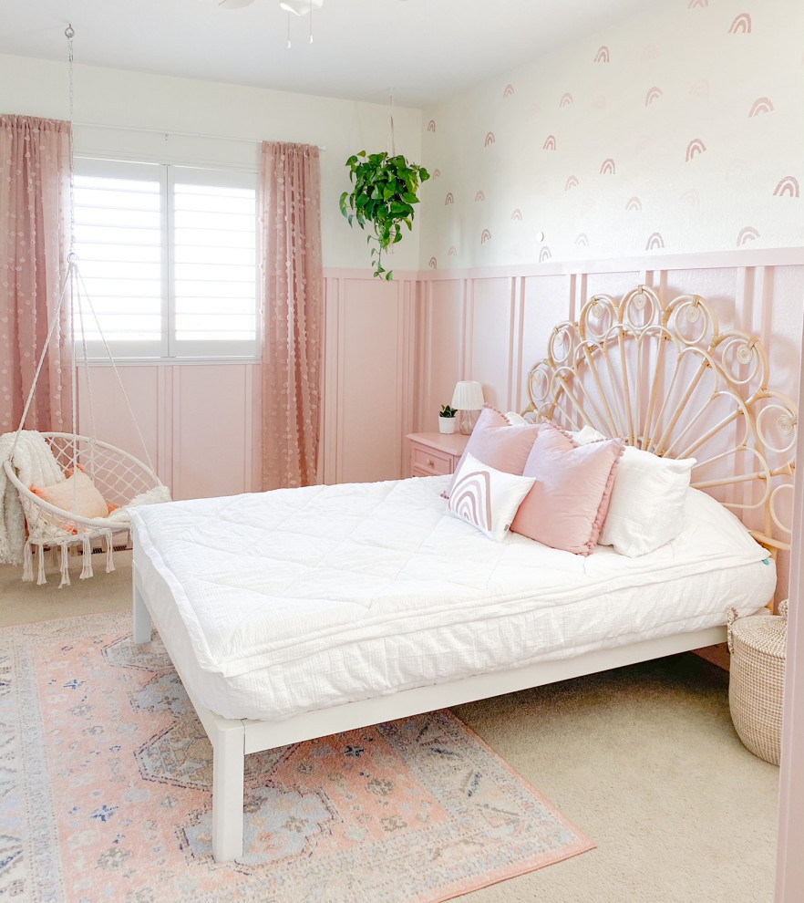 Photo of a farmhouse kids' bedroom for girls in Denver with pink walls and wainscoting.