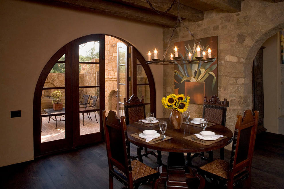 Inspiration for a mediterranean dining room in Austin with beige walls and dark hardwood floors.