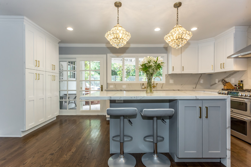 Inspiration for a large modern u-shaped medium tone wood floor and brown floor eat-in kitchen remodel in Los Angeles with an undermount sink, shaker cabinets, white cabinets, marble countertops, red backsplash, marble backsplash, stainless steel appliances and an island