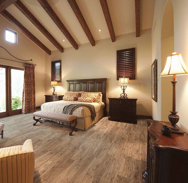 Inspiration for a large country master bedroom in Chicago with beige walls, medium hardwood floors, no fireplace and brown floor.
