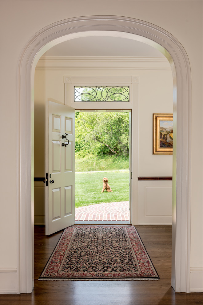 Inspiration for a traditional entryway in Philadelphia with white walls, a single front door, a white front door and dark hardwood floors.