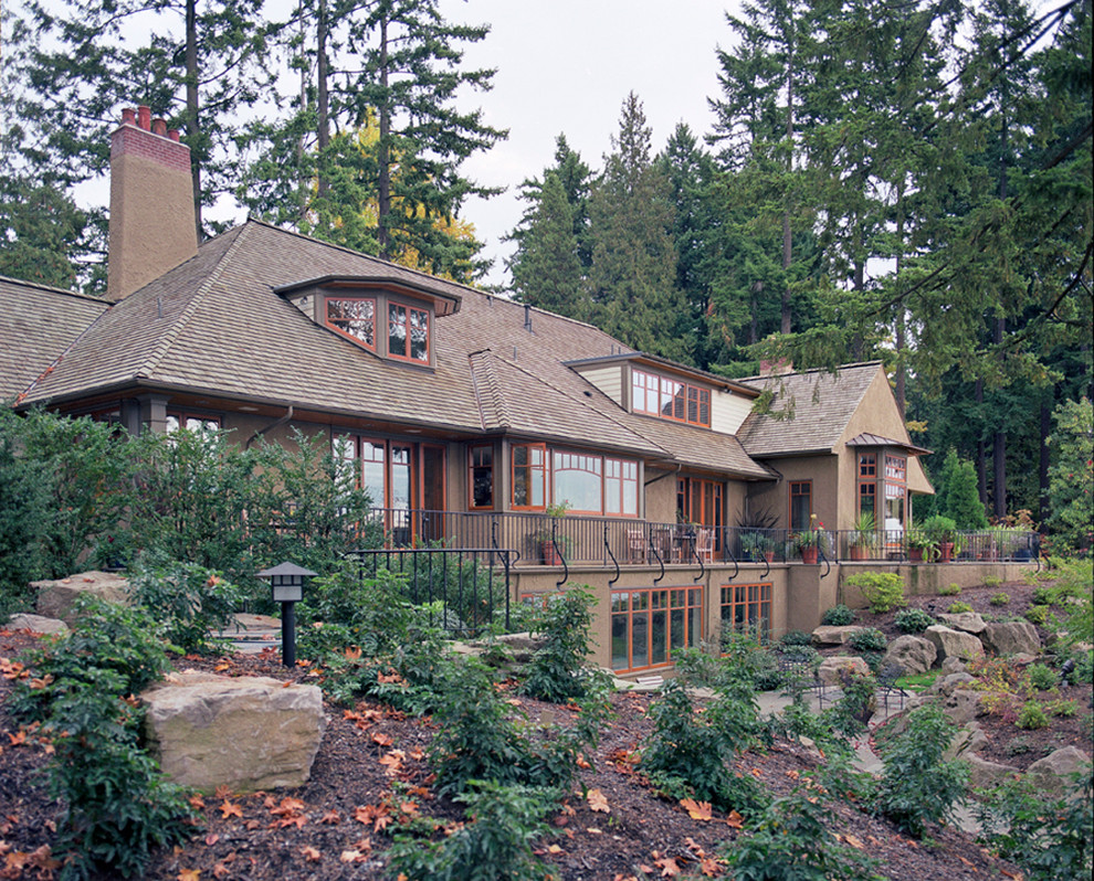 This is an example of a large traditional two-storey stucco grey exterior in Portland.