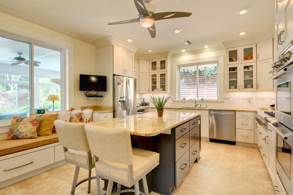 Mid-sized transitional u-shaped vinyl floor eat-in kitchen photo in Miami with an undermount sink, shaker cabinets, white cabinets, granite countertops, white backsplash, subway tile backsplash, stainless steel appliances and an island