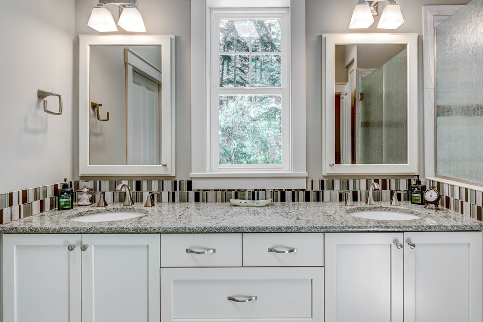 Mid-sized arts and crafts master bathroom in Seattle with shaker cabinets, a curbless shower, a two-piece toilet, glass sheet wall, porcelain floors, an undermount sink, granite benchtops and a hinged shower door.