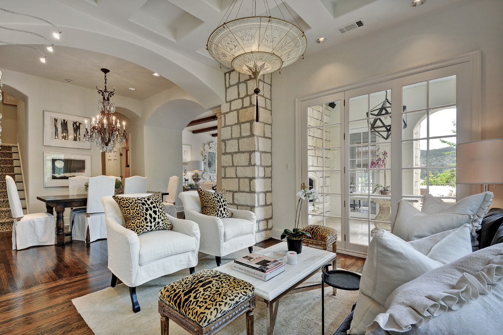 Inspiration for a mediterranean open concept living room in Austin with beige walls and dark hardwood floors.