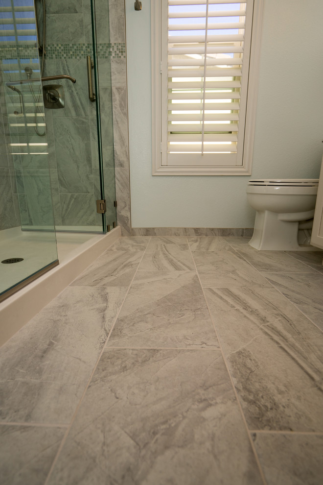 Inspiration for a large traditional master bathroom in Los Angeles with recessed-panel cabinets, white cabinets, an alcove shower, a two-piece toilet, yellow tile, ceramic tile, blue walls, travertine floors, a drop-in sink and quartzite benchtops.