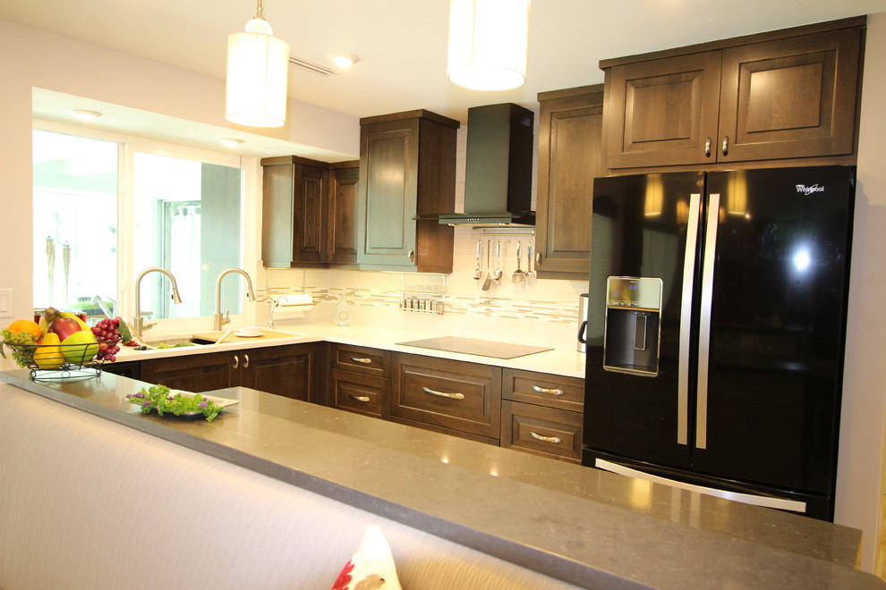 Inspiration for a mid-sized transitional l-shaped eat-in kitchen remodel in Miami with an undermount sink, flat-panel cabinets, gray cabinets, quartzite countertops, white backsplash, subway tile backsplash, black appliances and an island