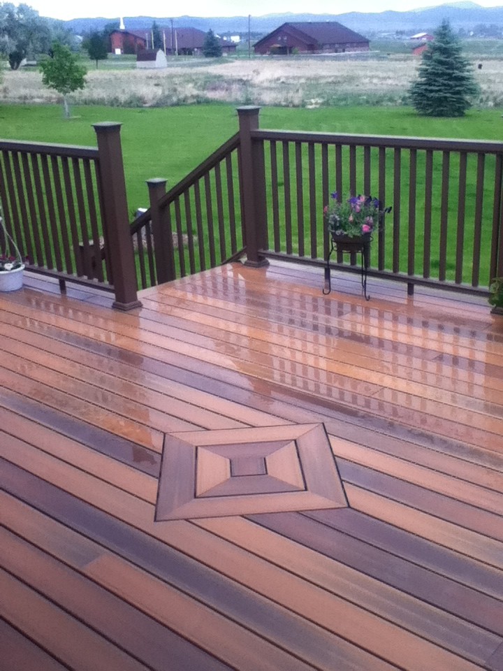 Large island style backyard deck photo with no cover