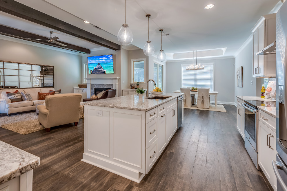 Inspiration for a mid-sized transitional l-shaped open concept kitchen remodel with an undermount sink, flat-panel cabinets, white cabinets, quartz countertops, white backsplash, glass tile backsplash, stainless steel appliances, an island and white countertops